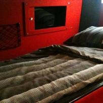 A typical bed with slider to see out of the window.